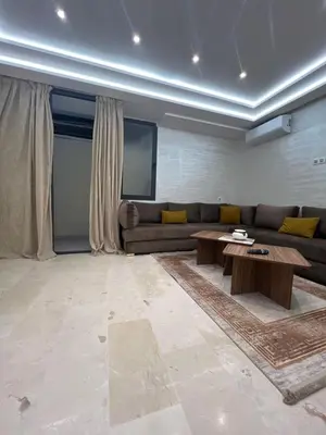 a living room with a couch and a table at Des appartements conçus pour votre confort in Marrakech