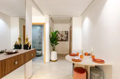 a dining room with a table with plates on it at Modern & Refined Apartment Majorelle Downtown in Marrakech