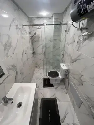 a white bathroom with a sink and a toilet at Residence miraj 24 in Marrakech