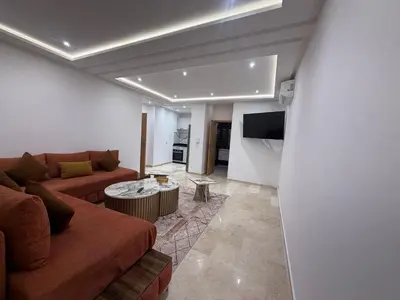 a living room with a couch and a table at Residence miraj in Marrakech