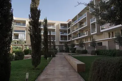 an apartment building with a bench in front of it at Mamounia loft by M&I in Marrakech