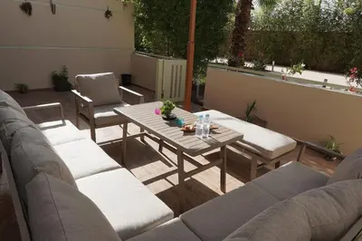 a patio with a wooden table and chairs and a table and chairs at Mamounia loft by M&I in Marrakech