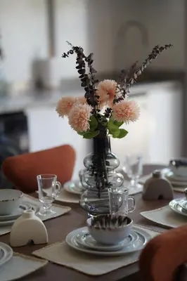 a table with a vase with flowers in it at Mamounia loft by M&I in Marrakech