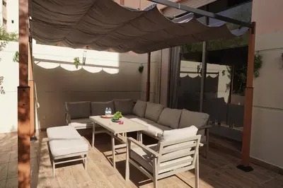 a patio with a couch and a table and chairs at Mamounia loft by M&I in Marrakech