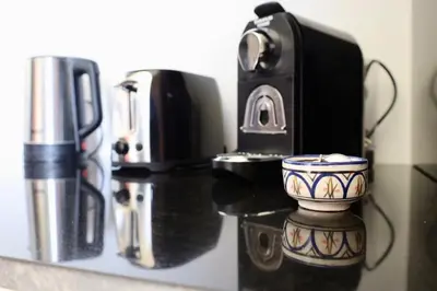 a counter with a coffee maker and a cup on it at Marrakech Noria Golf, cosy appartement 2 chambres in Marrakech