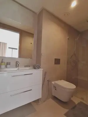 a bathroom with a toilet and a sink and a shower at Marrakech Noria Golf, cosy appartement 2 chambres in Marrakech