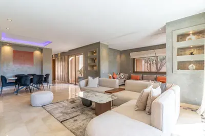 a living room with couches and a dining room at Luxury Villa Private Pool & Golf View 7 min to center in Marrakech