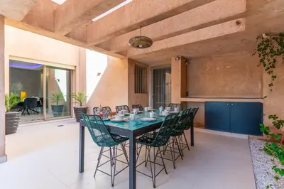 a dining room with a table and chairs at Luxury Villa Private Pool & Golf View 7 min to center in Marrakech