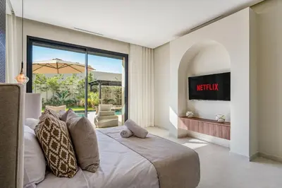 a bedroom with a bed and a view of a patio at Villa Lilas-Luxe Pool, Steam Room & Gym in Segraga