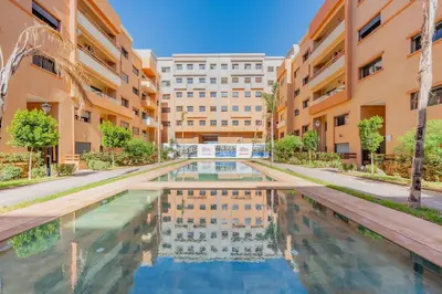 an apartment complex with a pool in a courtyard at AFCON Stay Gueliz 2BR & Pool, Parking & Wi-Fi in Marrakech