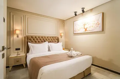 a bedroom with a large bed with white pillows at Gueliz Prime 2BR Perfect Central Stay in Marrakech in Marrakech