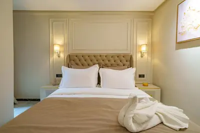 a bedroom with a large bed with white sheets and pillows at Gueliz Prime 2BR Perfect Central Stay in Marrakech in Marrakech