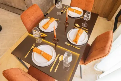 a black table with plates of food on it at Cozy Gueliz Apartment , Access to Pool , Central Location in Marrakech