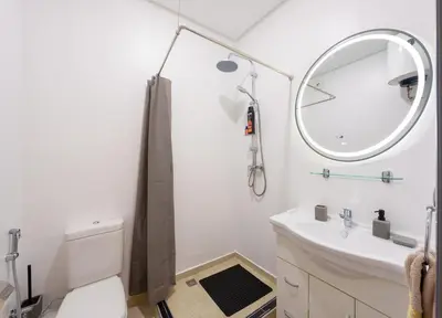 a white bathroom with a sink and a mirror at Cozy 1BR Apt Fast WiFi Peaceful Spot n Center of Gueliz Marrakech in Marrakech