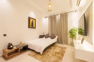 a bedroom with a bed and a table and a couch at Cozy 1BR Apt Fast WiFi Peaceful Spot n Center of Gueliz Marrakech in Marrakech