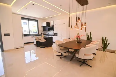 a dining room and kitchen with a table and chairs at Villa Marrakech - Argan Golf - Swimming Pool in Marrakech