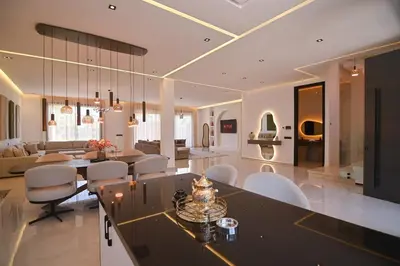 a kitchen and living room with a table and chairs at Villa Marrakech - Argan Golf - Swimming Pool in Marrakech