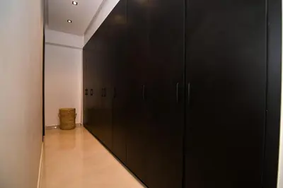 a row of black cabinets in a hallway at Villa Marrakech - Argan Golf - Swimming Pool in Marrakech