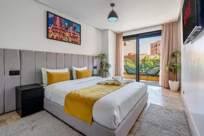 a bedroom with a large bed and a large window at Modern 1BR , Balcony & WiFi & 2min Eden in Marrakech