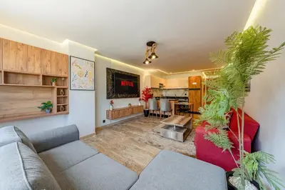 a living room with a couch and a table at Modern 1BR , Balcony & WiFi & 2min Eden in Marrakech