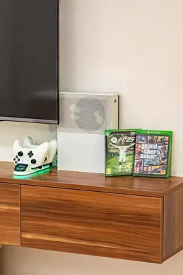 a shelf with a video game and a dvd at Modern 1BR , Cinema & Xbox , Central Guéliz in Marrakech