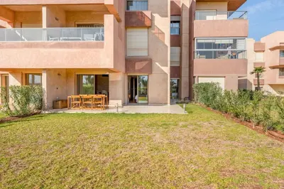 an empty yard in front of a building at Spacious 2BR , Pool & Garden , Golf View , Fast WiFi in Marrakech