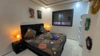a bedroom with a bed with a blue stuffed animal on it at Appartement 3 chambres jaccuzi in Marrakech