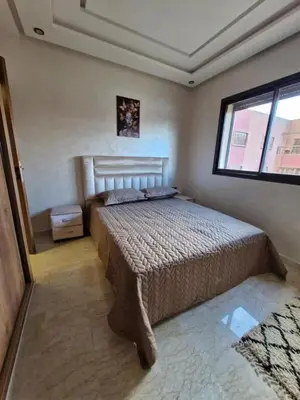 a bedroom with a bed and a window at Appartement 3 chambres jaccuzi in Marrakech