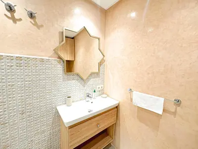 a bathroom with a sink and a mirror at Escapade Gueliz - Central & parking Privé in Marrakech