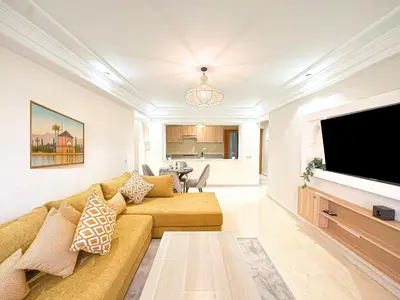 a living room with a couch and a flat screen tv at Escapade Gueliz - Central & parking Privé in Marrakech