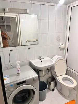 a bathroom with a washing machine and a sink at Tumsilt in Marrakech