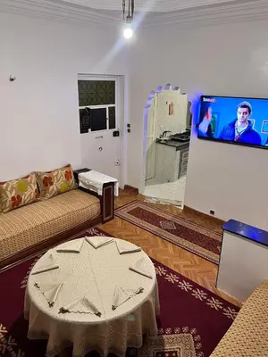 a living room with a couch and a flat screen tv at Tumsilt in Marrakech