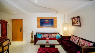 a living room with a couch and a table at Best Location in Marrakech! Modern Chic Apartment in Marrakech