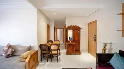 a living room with a couch and a table and chairs at Best Location in Marrakech! Modern Chic Apartment in Marrakech