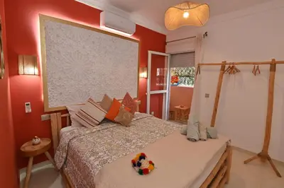 a bedroom with a bed with a large screen above it at Stylish appartment,5min to airport fiber&netflix in Marrakech