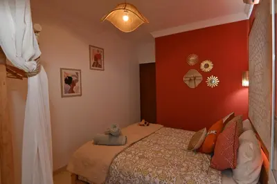 a bedroom with a bed and a red wall at Stylish appartment,5min to airport fiber&netflix in Marrakech