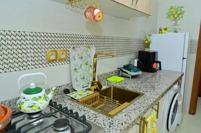 a kitchen counter with a sink and a stove at Stylish appartment,5min to airport fiber&netflix in Marrakech