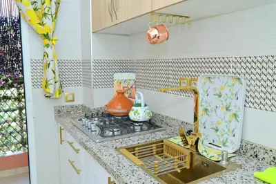 a kitchen counter with a stove and a sink at Stylish appartment,5min to airport fiber&netflix in Marrakech