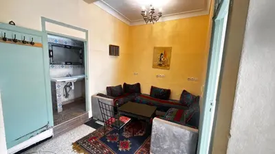 a living room with a couch and a table at Les appartements de la Koutoubia in Marrakech