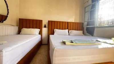 two beds sitting next to each other in a room at Les appartements de la Koutoubia in Marrakech