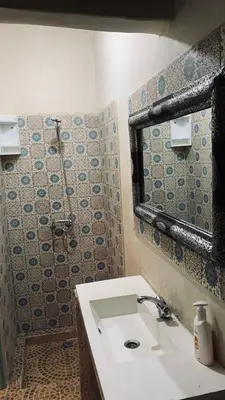 a bathroom with a sink and a mirror at Les appartements de la Koutoubia in Marrakech