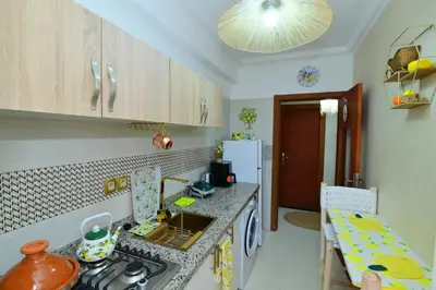 a kitchen with a stove and a counter top at Stylish apartment, 5 min to airport fiber&Netflix in Marrakech