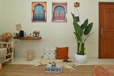 a living room with a couch and a potted plant at Stylish apartment, 5 min to airport fiber&Netflix in Marrakech