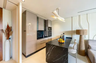a kitchen with a black counter in a room at Guéliz Centre Haut Standing in Marrakech