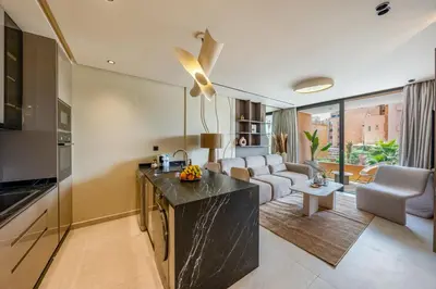 a kitchen and living room with a couch and a table at Guéliz Centre Haut Standing in Marrakech