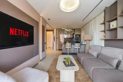 a living room with a couch and a tv at Guéliz Centre Haut Standing in Marrakech