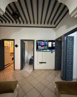 a living room with a tv on the wall at Stay here in Marrakech