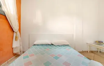 a bedroom with a bed with a blue and pink at Stay here in Marrakech