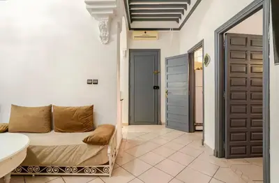 a bedroom with a bed and a sink and a door at Stay here in Marrakech