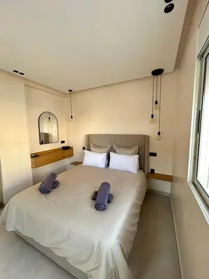 a bedroom with a large bed with two pillows on it at Appartement 2 chambres neuf Marjane Rte de Casa in Marrakech